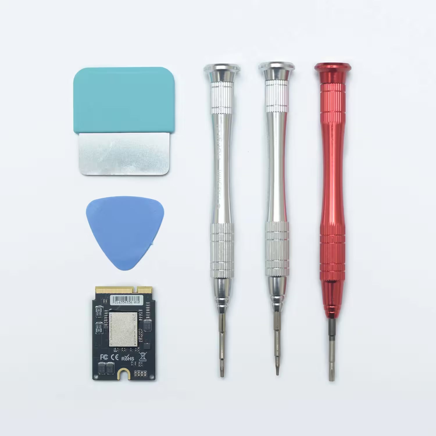 Set of tools including screwdrivers, a pick, and a small electronic component on a white background