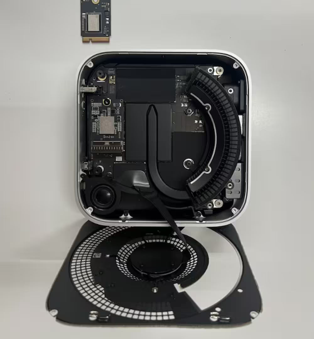 Technical components of a Mac Mini M4 on a white background