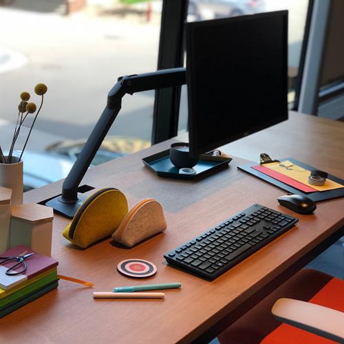 Ergotron MXV — arm in raised position on desk